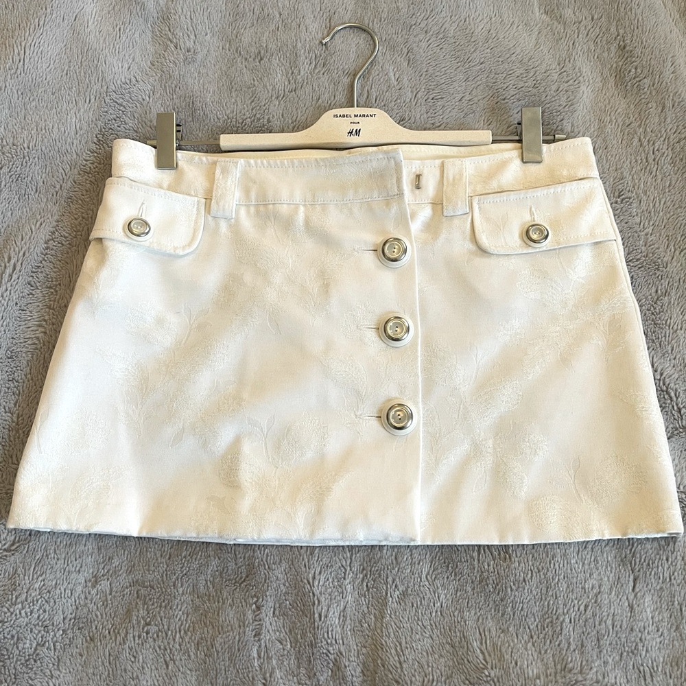 Dolce and Gabbana floral embossed white button up mini skirt.